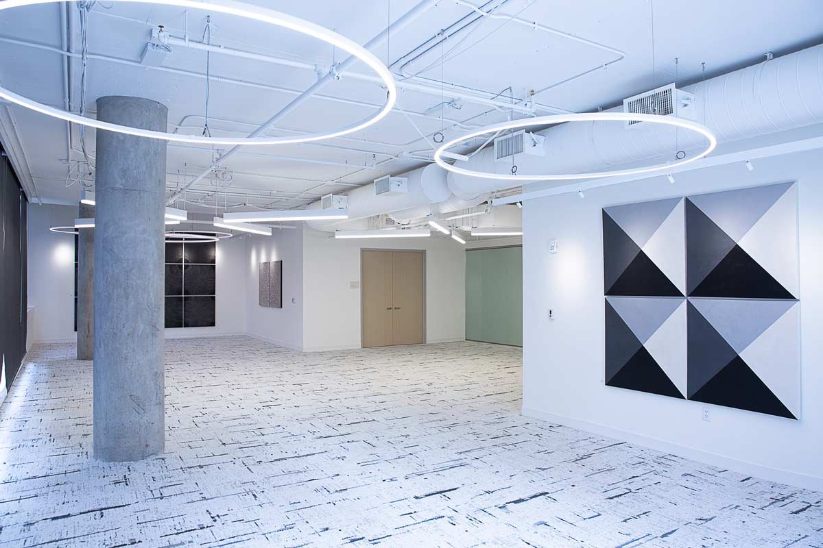 Bright white empty office with bright lighting and art