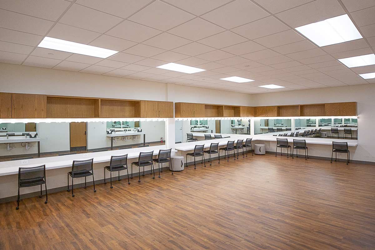 Long shot showing all the mirrors and chairs of the dressing area