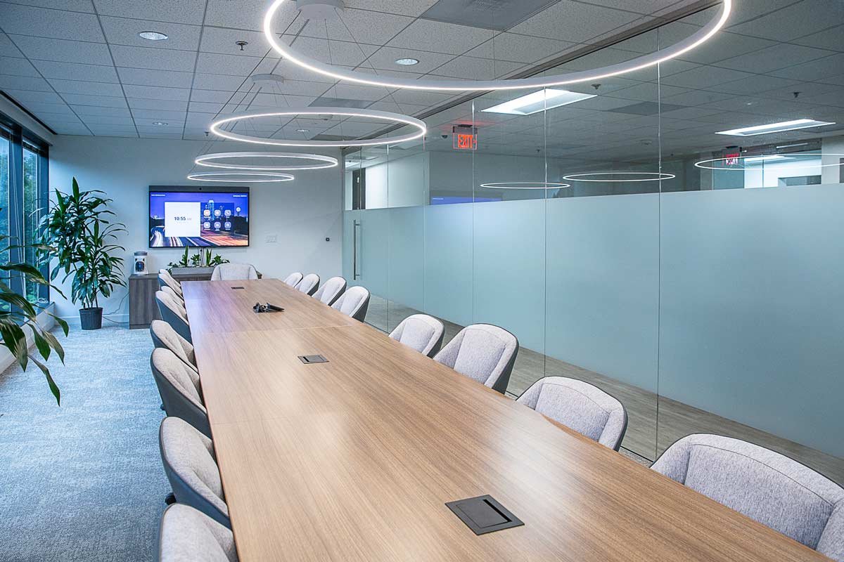 Conference room with long table, lighting and frosted glass walls