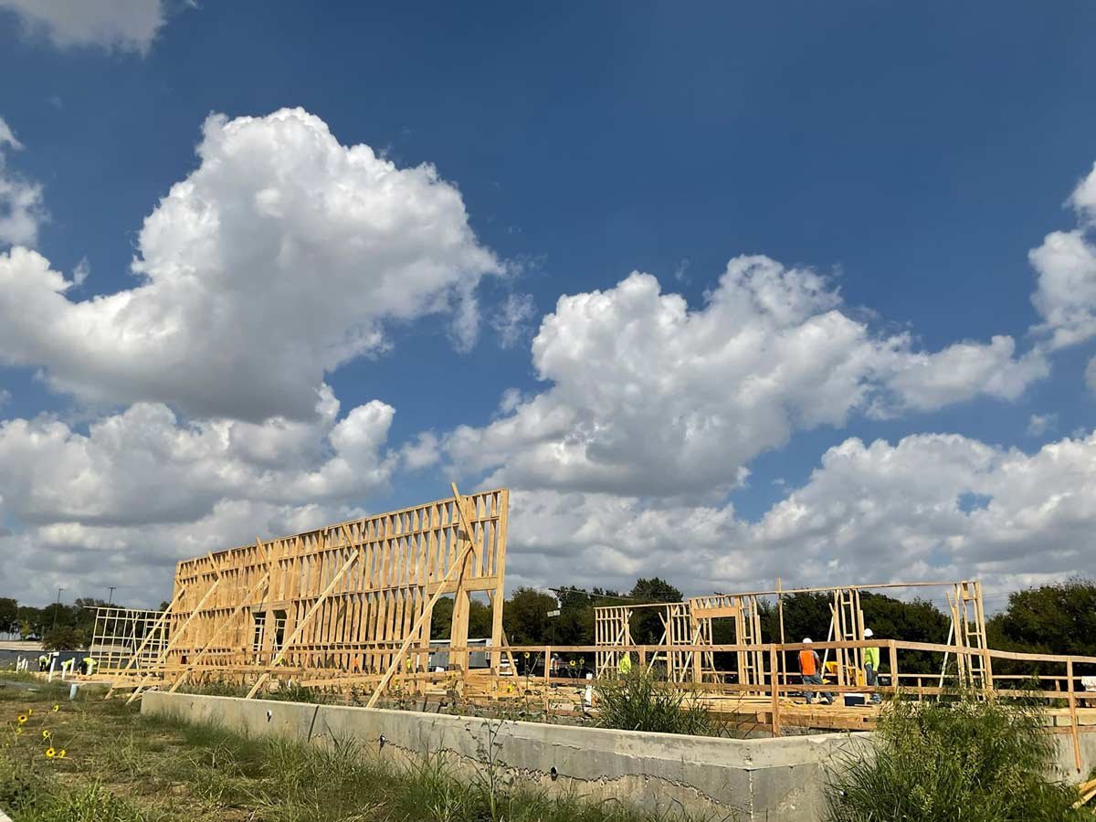 Beginning of framing on slab on a sunny day with big bright clouds