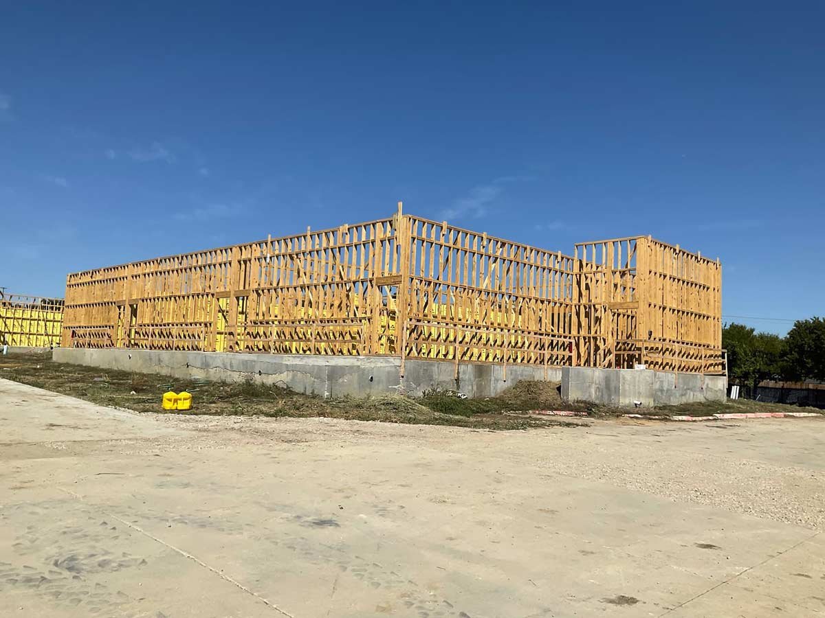 Building framing with a bright blue sky