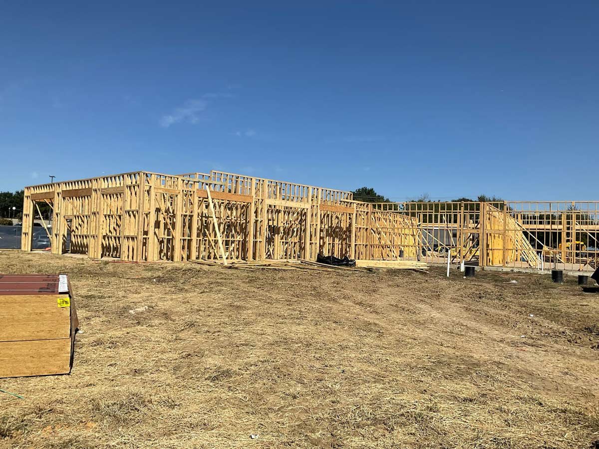 Building framing from the front side with empty land