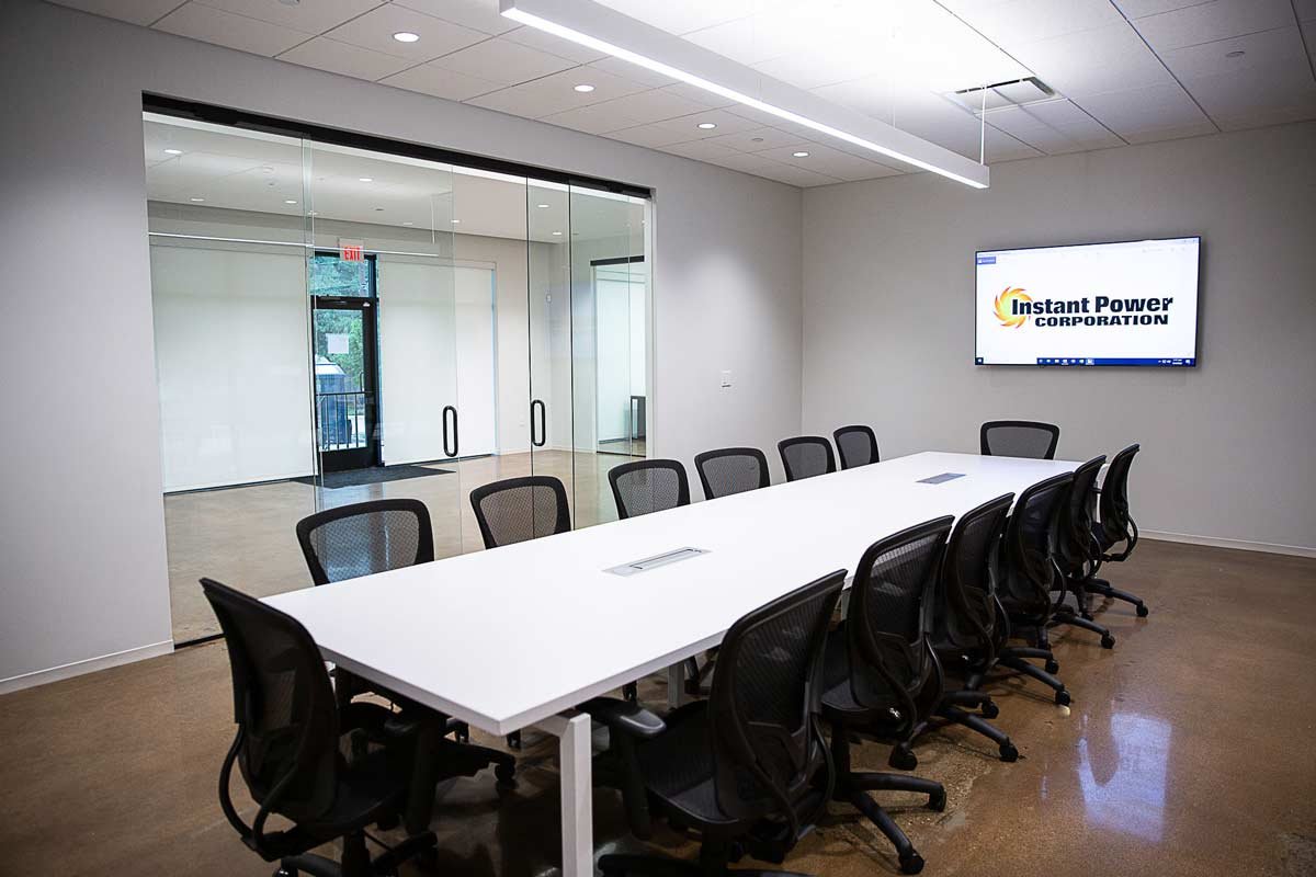 Conference room with tv on wall and glass wall