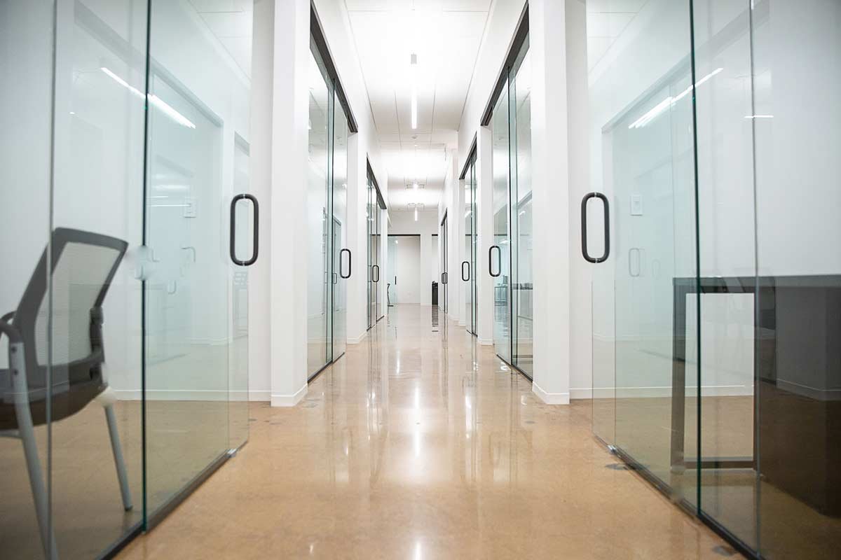 Long hallway with glass doors to all the offices