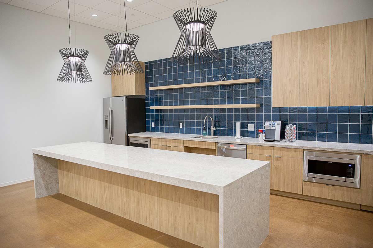 Office kitchen area with counter, sink and microwave