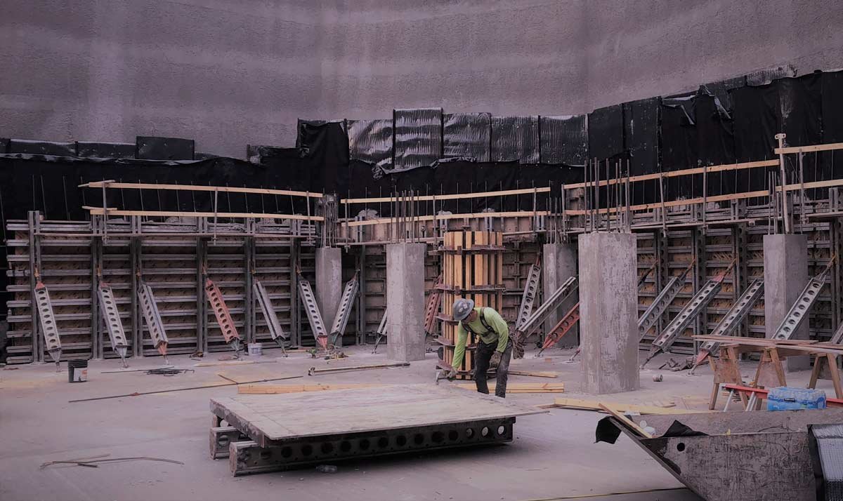 Perimeter wall form with worker in middle of open area