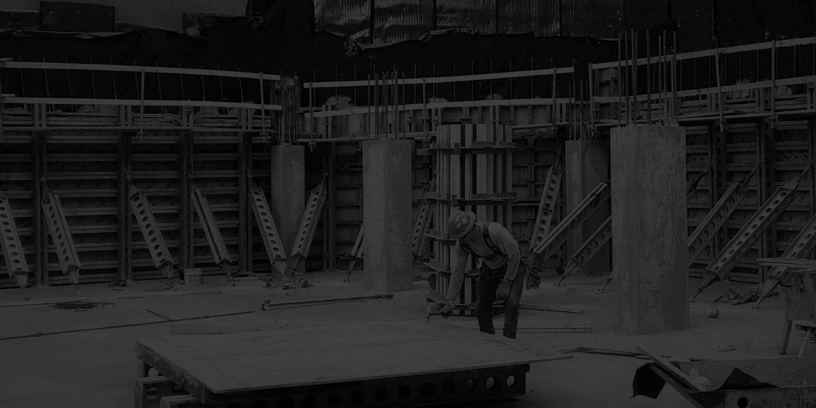 Worker in garage pit during construction