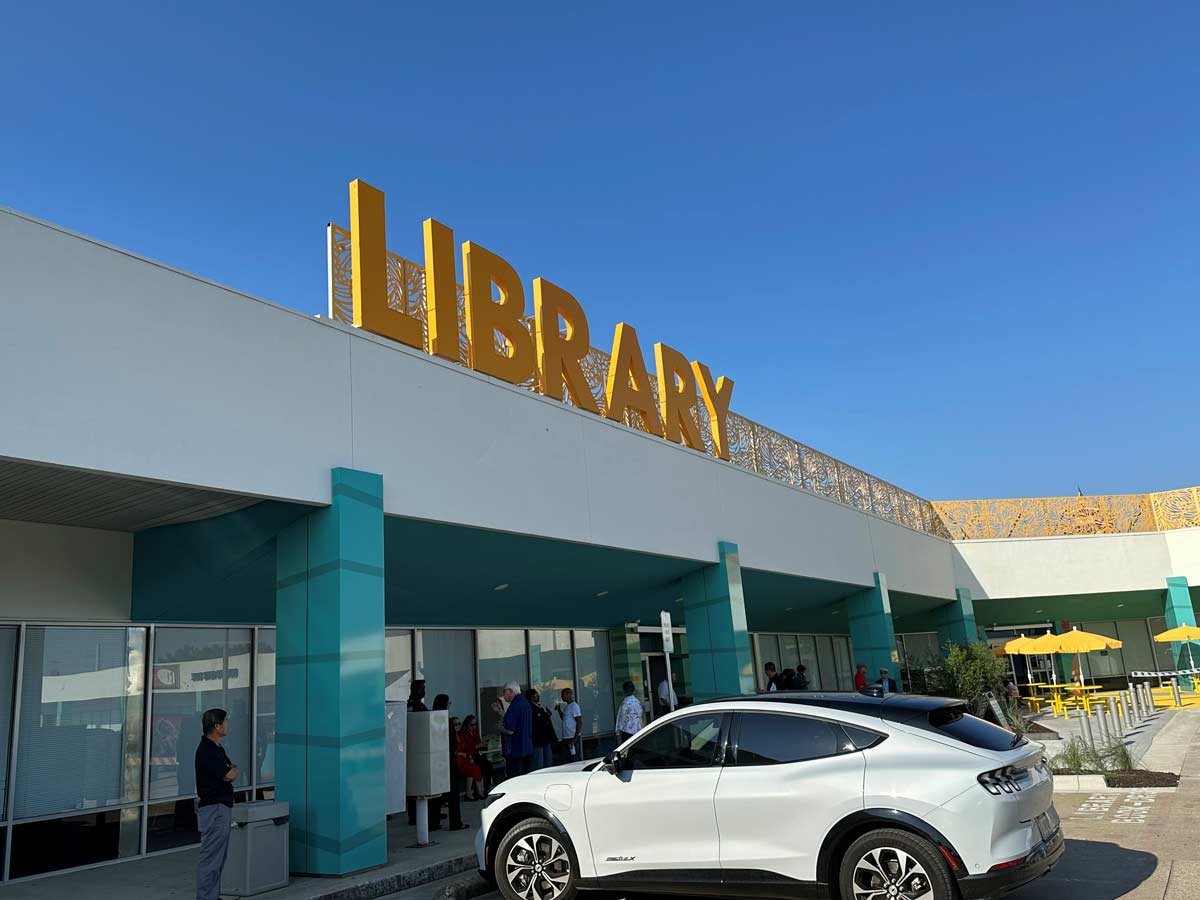 Library sign in front of parking lot