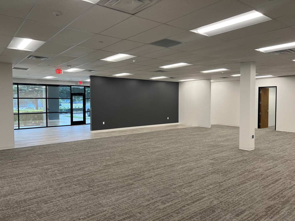 Large open office area showing front doors and reception area