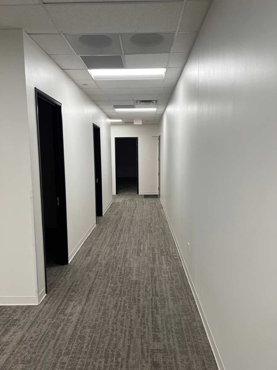 White hallway with black doorways