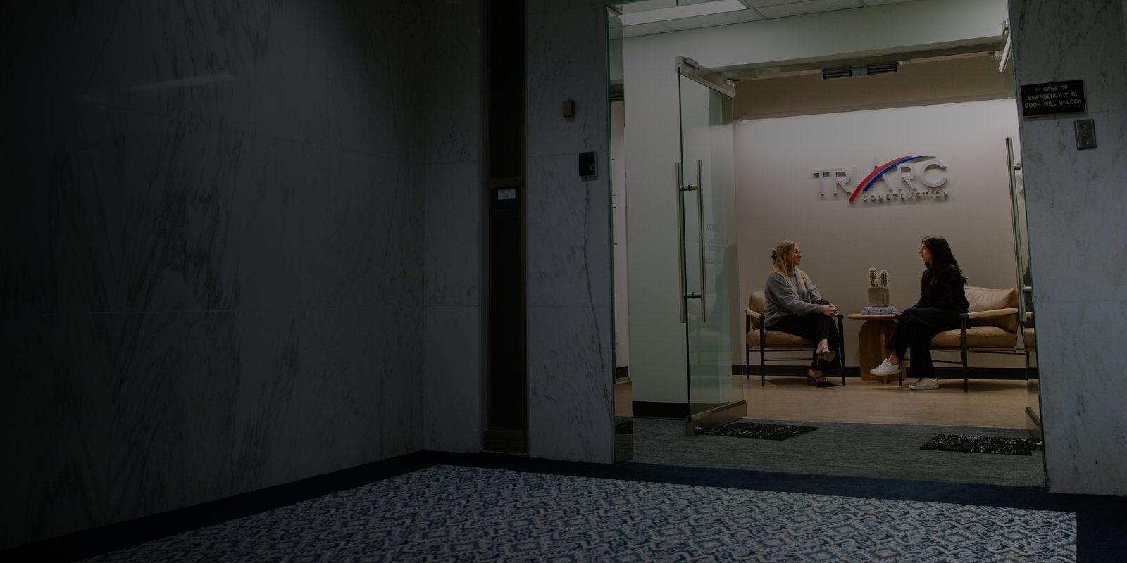 Two women chatting in the TriArc side room