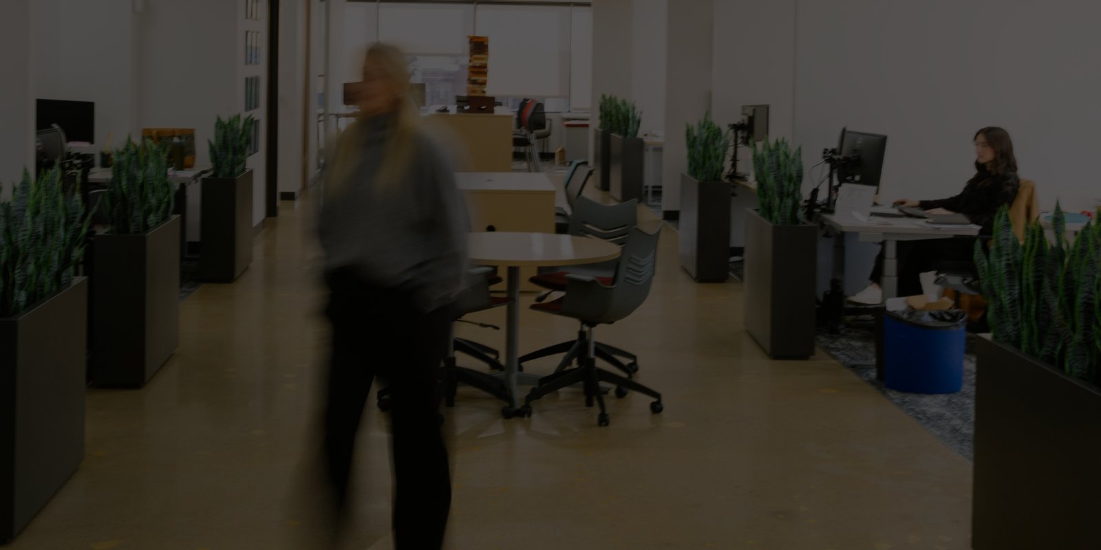 Blurred image of office interior with working moving about