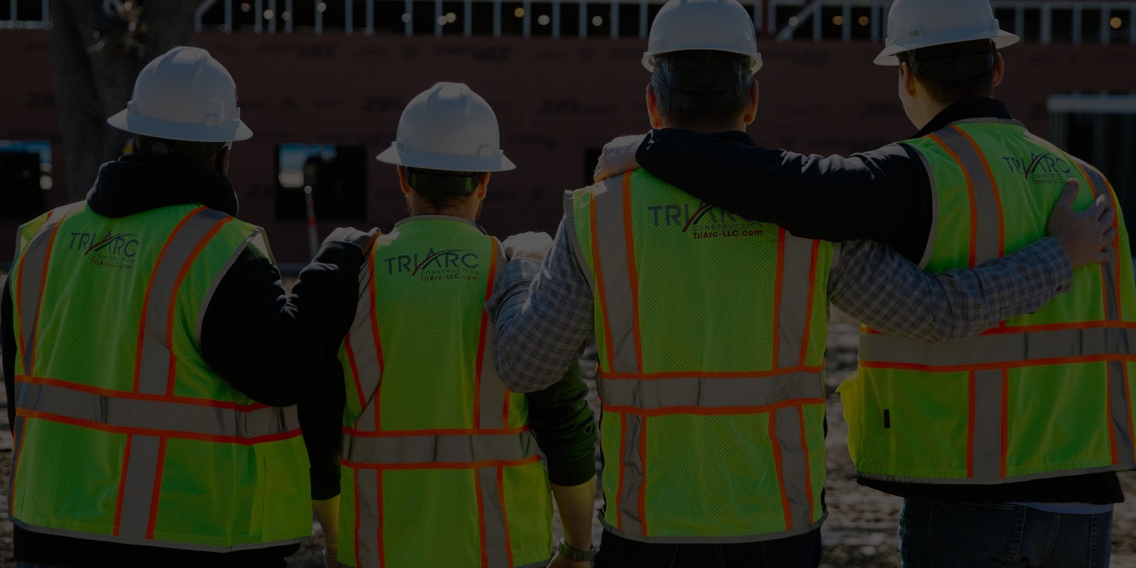 Four workers on job site with TriArc reflective vests
